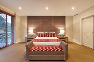 a bedroom with a large bed with a large headboard at The Bay Residence, Dunsborough WA in Quindalup