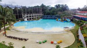 an image of a large swimming pool at a resort at Forest Crest Nature Hotel and Resort Powered by ASTON in Nasugbu