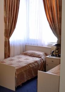 a bedroom with a bed and a window at Hotel 3A in Tirana