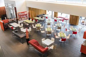 an overhead view of a restaurant with tables and chairs at Kyriad Vienna Altmannsdorf in Vienna