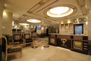 a salon with chairs and a tv in a room at Al Adl Jewel Hotel in Mecca