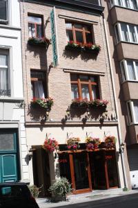 a building with flower boxes on the front of it at Logies Ocelot in Ostend