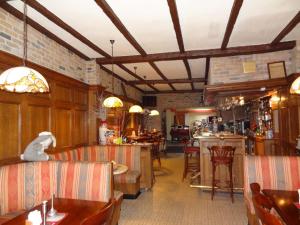 a restaurant with a bar and some chairs and tables at Logies Ocelot in Ostend
