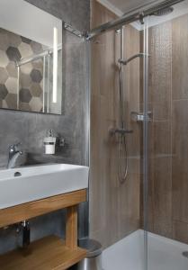 a bathroom with a sink and a shower at Rezidence Adalbert in Valtice