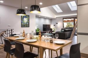 a dining room and living room with a table and chairs at Rezidence Adalbert in Valtice +18 photos
