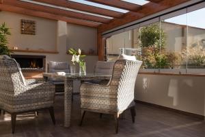 a dining room with a table and chairs and a fireplace at Rezidence Adalbert in Valtice