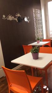 a group of tables with orange chairs in a room at Casa Bella Pantheon in Rome