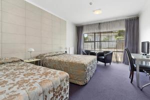 Ένα ή περισσότερα κρεβάτια σε δωμάτιο στο Amethyst Court Motor Lodge