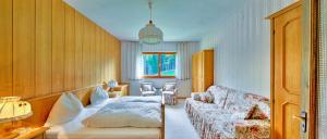 ein Wohnzimmer mit einem Sofa und einem Bett in der Unterkunft Ferienhaus Goldberg in Dellach