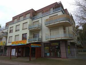 a white building with balconies on the side of it at Sonatka w Apartamentowcu Sonata in Międzywodzie