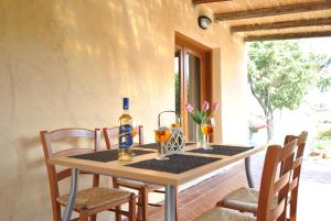 a table with two glasses and a bottle of wine at COUNTRY HOUSE HOLIDAY - Olbia in Olbia