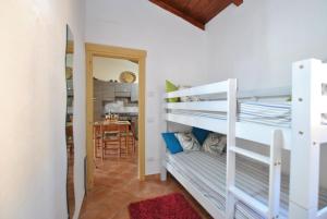 a room with two bunk beds and a dining room at COUNTRY HOUSE HOLIDAY - Olbia in Olbia