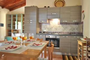 a kitchen with a table with glasses of wine at COUNTRY HOUSE HOLIDAY - Olbia in Olbia