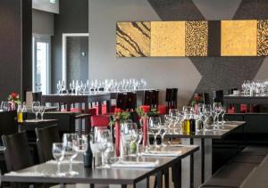 ein Esszimmer mit Tischen und Stühlen mit Weingläsern in der Unterkunft Boutique Hotel Bellevue Rheinfelden / Basel in Rheinfelden
