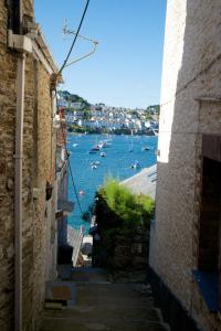 an alley with a view of a harbor with boats at Polmarine in Polruan