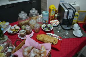 a table with pastries and other food items on it at B&B La Casa Bianca di Porto Conte in Porto Conte