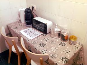 a table with a table cloth on it with a toaster at Mini Chic Downtown in Bologna