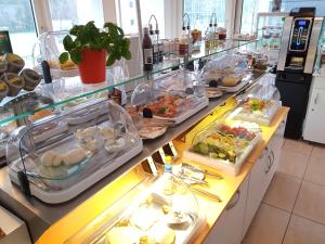 a kitchen filled with lots of different types of food at Hotel Aviva in Karlsruhe
