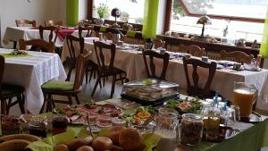 a dining room with two tables with plates of food at Zur Traube in Kestert