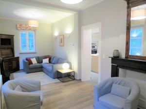 a living room with two couches and a fireplace at Gîte du Châtelet in Villers-la-Ville