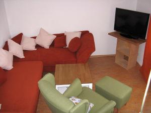 アルプシュタットにあるFerienwohnung "Zur Wasserlilie"のリビングルーム(ソファ、椅子、テレビ付)
