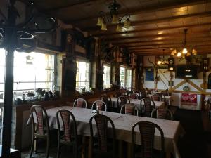 a dining room with a long table and chairs at Restaurant Pension-Anton in Jáchymov