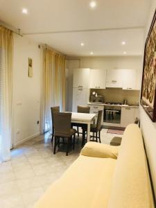 a kitchen and dining room with a table and chairs at ApartmentsPadova in Padova