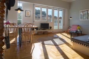 a kitchen and living room with a table and chairs at Auntie’s Home in Athens