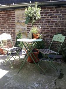 deux chaises et une table avec des plantes en pot dans l'établissement My Little Garden -Parking gratuit 500m -Coeur historique -La Clef de Honfleur, à Honfleur