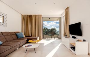 a living room with a couch and a tv at Villa Bellevue Bast in Baška Voda