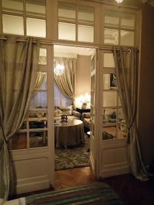 a door leading to a living room with a table at New West Room in La Madeleine