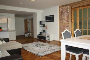 a kitchen and living room with a table and chairs at Old Town Niguliste Residence in Tallinn