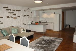 a kitchen and living room with a couch and a table at Old Town Niguliste Residence in Tallinn