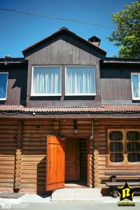 a log cabin with a large window and a door at Hostel Hola in Chernihiv