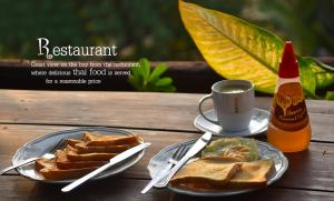 a table with a plate of toast and a cup of coffee at Tha Khao Bay View in Ko Yao Noi