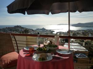 a table with plates of food on top of a balcony at Apartment with Amazing View & parking in Kavála