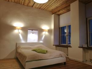 a bedroom with a bed and two windows at Old Town Niguliste Residence in Tallinn