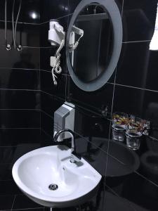 a bathroom with a white sink and a mirror at Motel Neno in Bijeljina
