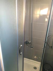 a shower with a glass door in a bathroom at Motel Neno in Bijeljina