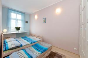 Posteľ alebo postele v izbe v ubytovaní Apartament Miami