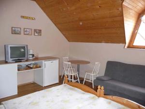 a living room with a couch and a table at Apartmanház Sipos Siófok in Siófok