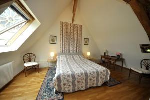 a bedroom with a bed in a attic at Grange du Plessis in Segré