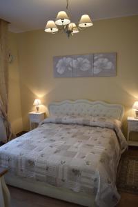 a bedroom with a bed with a white comforter at B&B Mercedes in Bologna