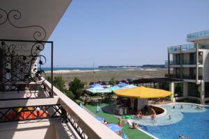 a view of a pool from a balcony of a hotel at Golden Dunes Primorsko Apartments in Primorsko