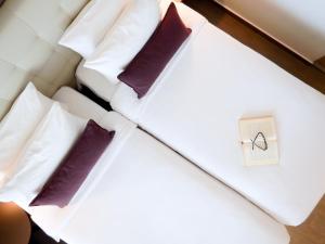 Łóżko lub łóżka w pokoju w obiekcie Gkeea Boutique Hotel