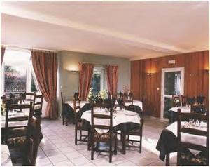 a restaurant with tables and chairs in a room at La Source du Mont in Saint-Martin-Valmeroux
