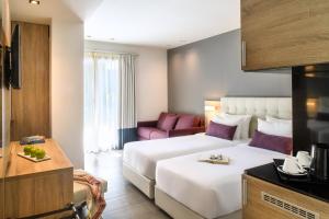 Łóżko lub łóżka w pokoju w obiekcie Gkeea Boutique Hotel