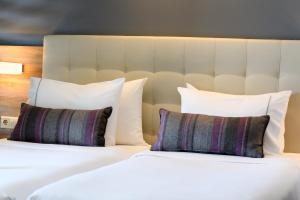 Łóżko lub łóżka w pokoju w obiekcie Gkeea Boutique Hotel