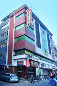 a building with a colorful facade on a street at Grand Choice in Bangalore