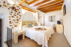 a bedroom with a bed and a table in a room at Agroturismo rural Can Prats in Sant Carles de Peralta